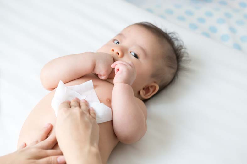 newborn baby being wiped down in their nappy change after having their first bath